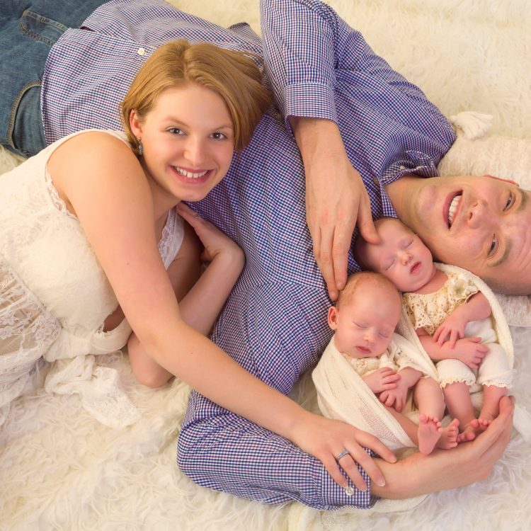Happy,Parents,Posing,With,Their,Newborn,Identical,Twins